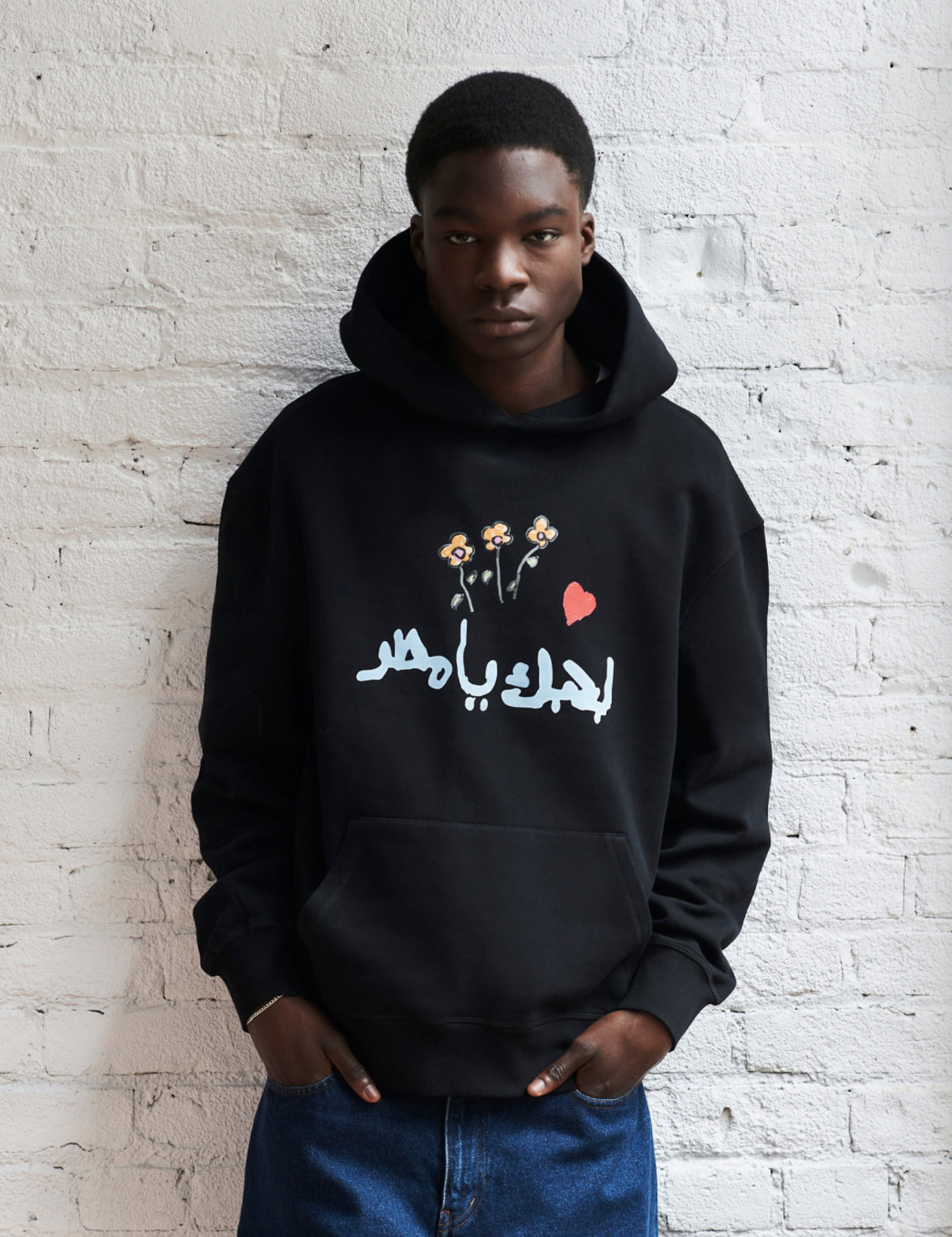 Juslin wears the Kotn x KWW Big Heart Essential Hoodie in Black