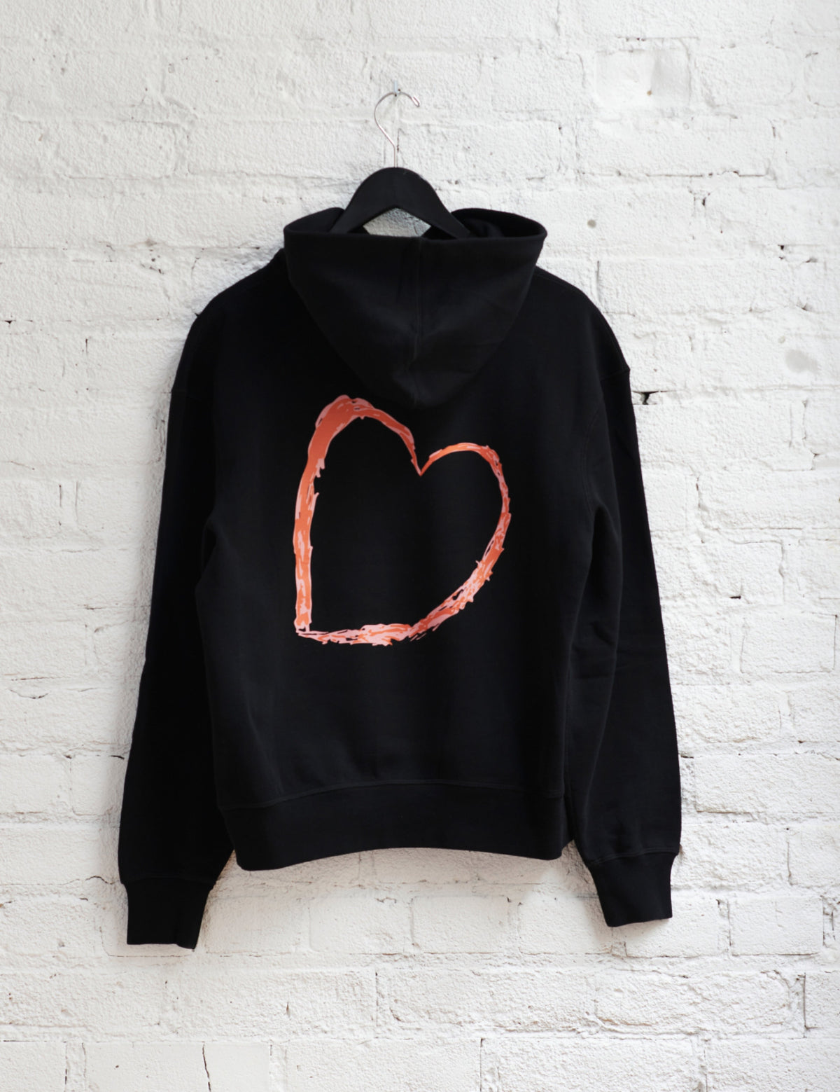 Juslin wears the Kotn x KWW Big Heart Essential Hoodie in Black